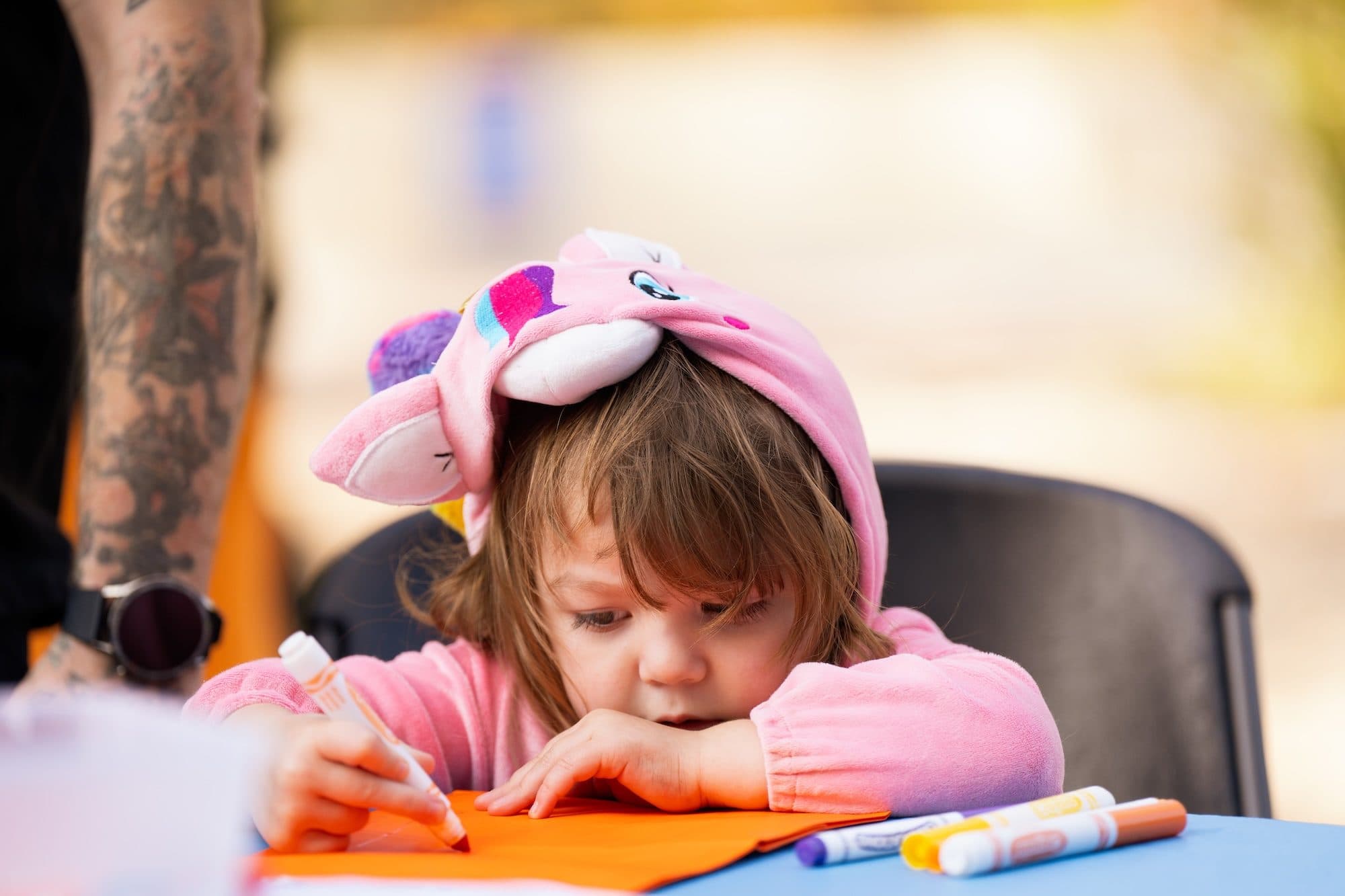 Child Coloring in Animal-Themed Hoodie